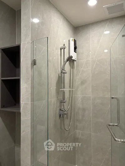 Modern bathroom with sleek glass shower and elegant tile design