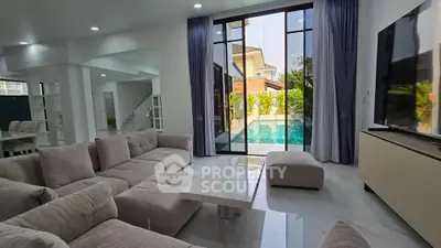 Luxurious living room with pool view and modern decor