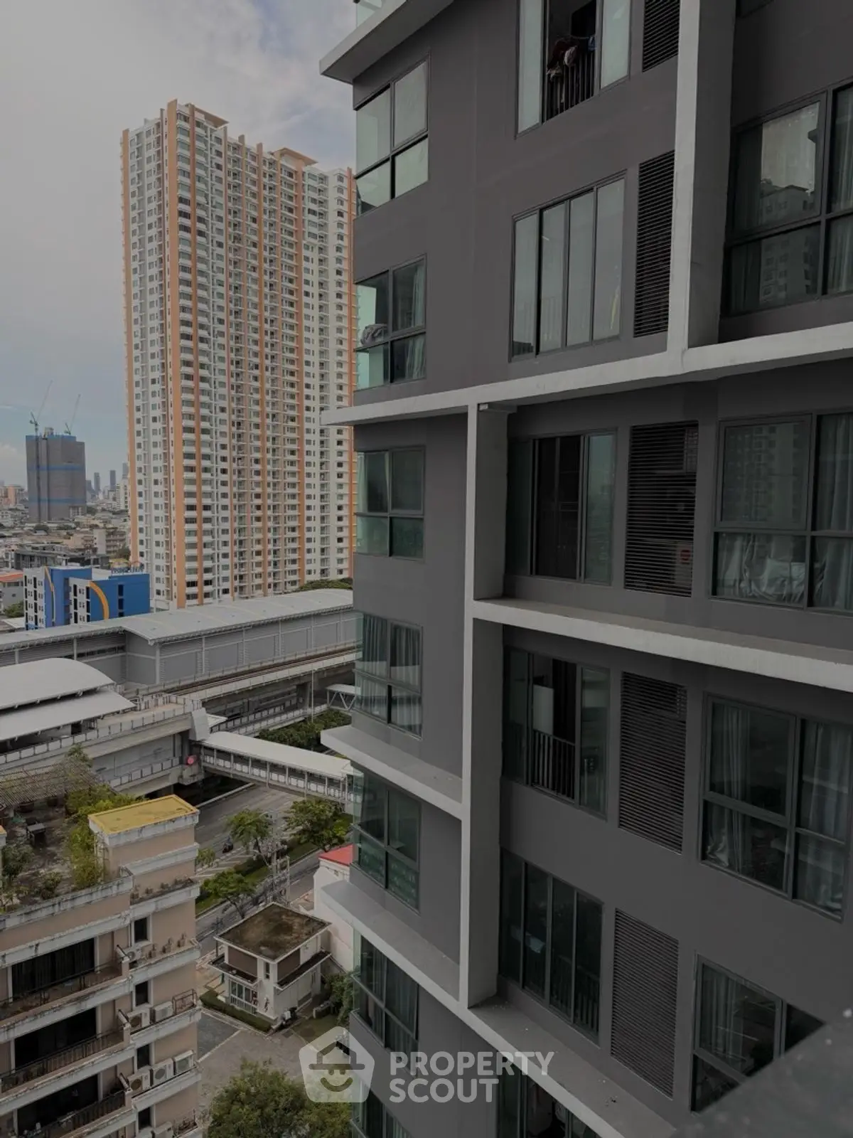 Modern high-rise apartment building with city skyline view