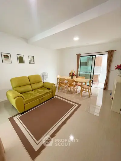 Spacious living room with modern decor and balcony access