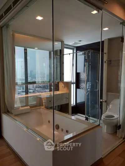 Luxurious modern bathroom with city view, featuring a glass-enclosed bathtub and shower area.