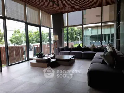 Spacious modern living room with large windows and stylish furniture