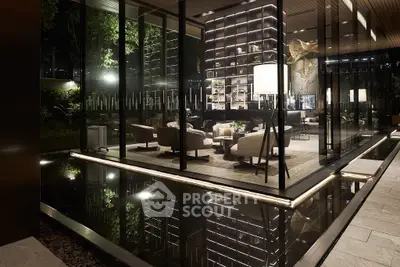 Luxurious modern living room with floor-to-ceiling glass walls overlooking a serene water feature.