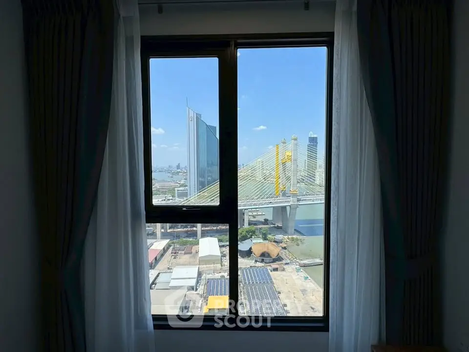 Stunning cityscape view from a high-rise apartment window, showcasing modern architecture and a vibrant urban skyline.