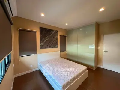 Spacious bedroom with modern design, featuring a large bed and stylish decor, perfect for relaxation.