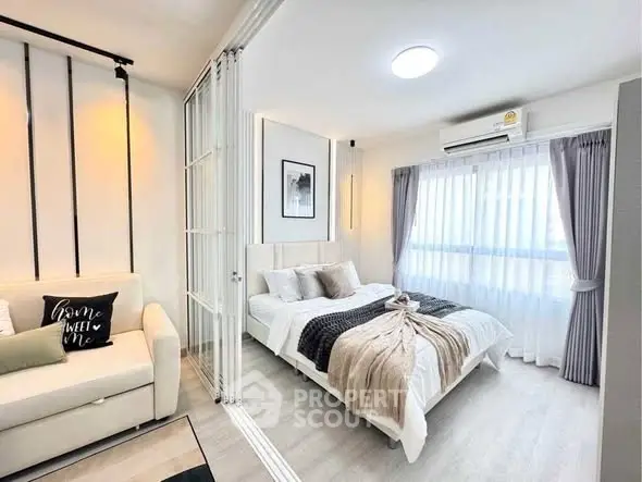 Modern bedroom with cozy decor and natural light in a stylish apartment.