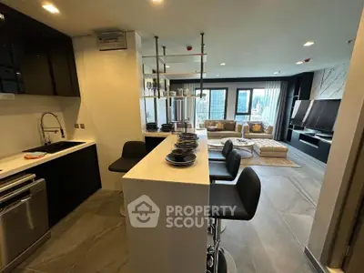 Modern open-layout kitchen and living room with city view, sleek design, and stylish furnishings.