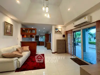 Spacious living room with modern decor and open layout leading to a patio.