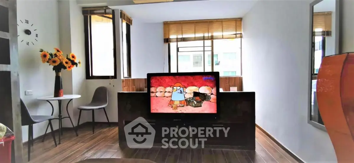 Modern living room with stylish decor and large windows offering natural light.