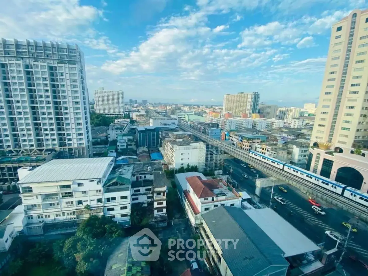 Stunning cityscape view from high-rise apartment with clear blue sky and urban skyline.
