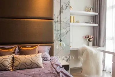 Luxurious bedroom with elegant decor and natural light, featuring a cozy bed and stylish workspace.