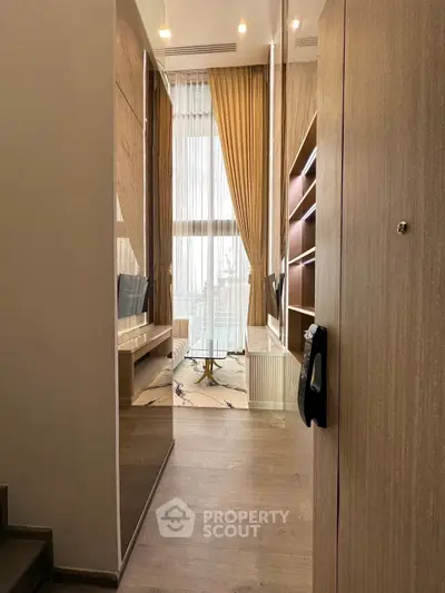 Luxurious high-ceiling living room with elegant decor and large windows offering stunning views.