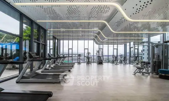 Luxurious modern gym with panoramic city views and state-of-the-art equipment in a high-end residential building.