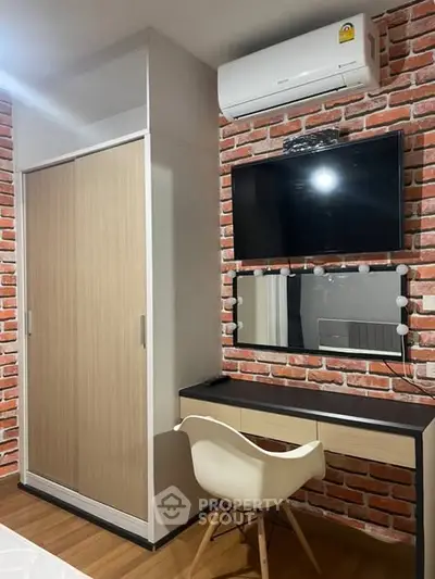Stylish bedroom with modern furniture and exposed brick wall design.
