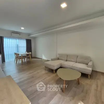 Spacious modern living room with wooden flooring and stylish furniture