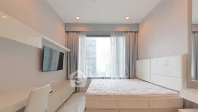 Modern bedroom with large window and city view, featuring sleek furniture and neutral tones.