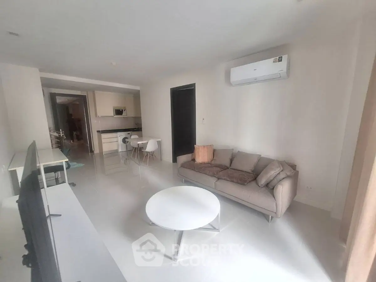 Modern living room with sleek furniture and open kitchen layout