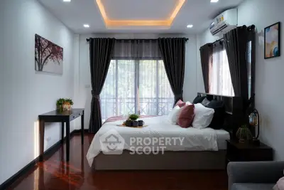Elegant bedroom with large windows, stylish decor, and cozy ambiance, perfect for relaxation and comfort.