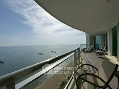 Stunning oceanfront balcony with panoramic sea views and modern seating area.