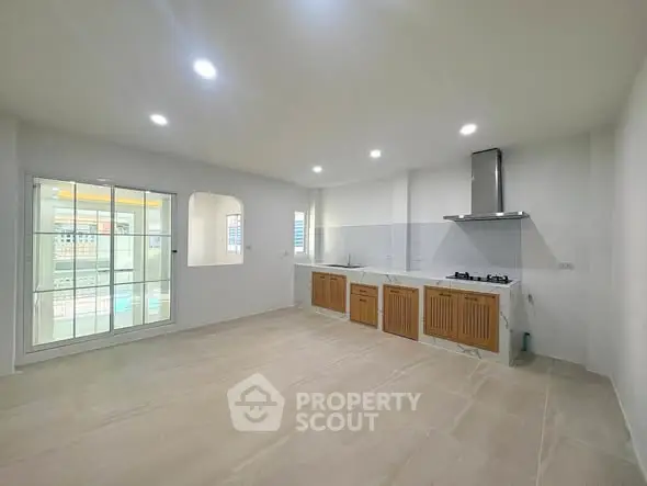 Spacious modern kitchen with gas stove and sleek cabinetry