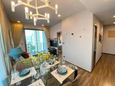 Modern living room with elegant dining setup and city view from balcony.