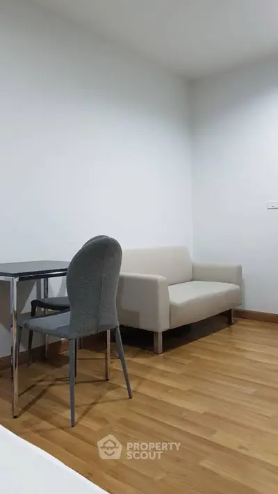 Modern minimalist living room with sleek furniture and wooden flooring