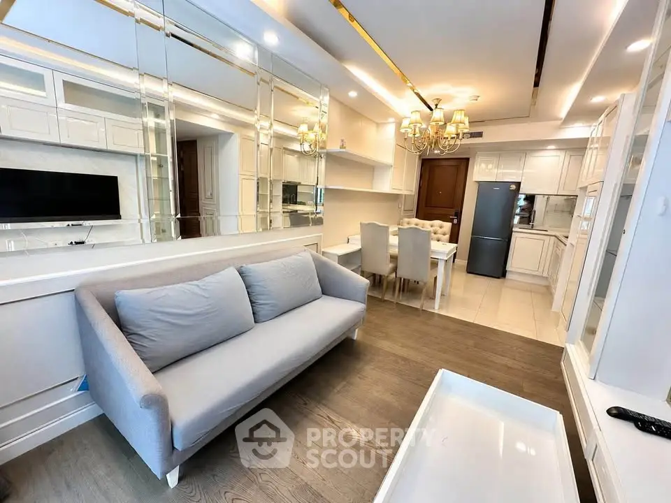 Elegant living room with modern kitchen, stylish decor, and cozy seating in a contemporary apartment.