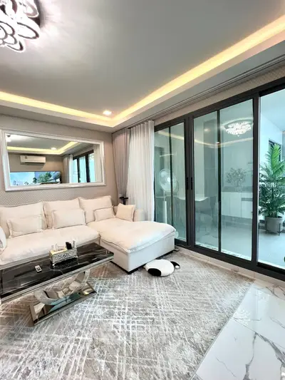 Luxurious living room with elegant decor and spacious balcony access.