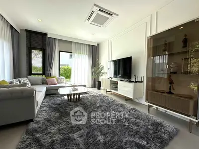 Luxurious modern living room with plush carpet, stylish furniture, and large windows offering natural light.