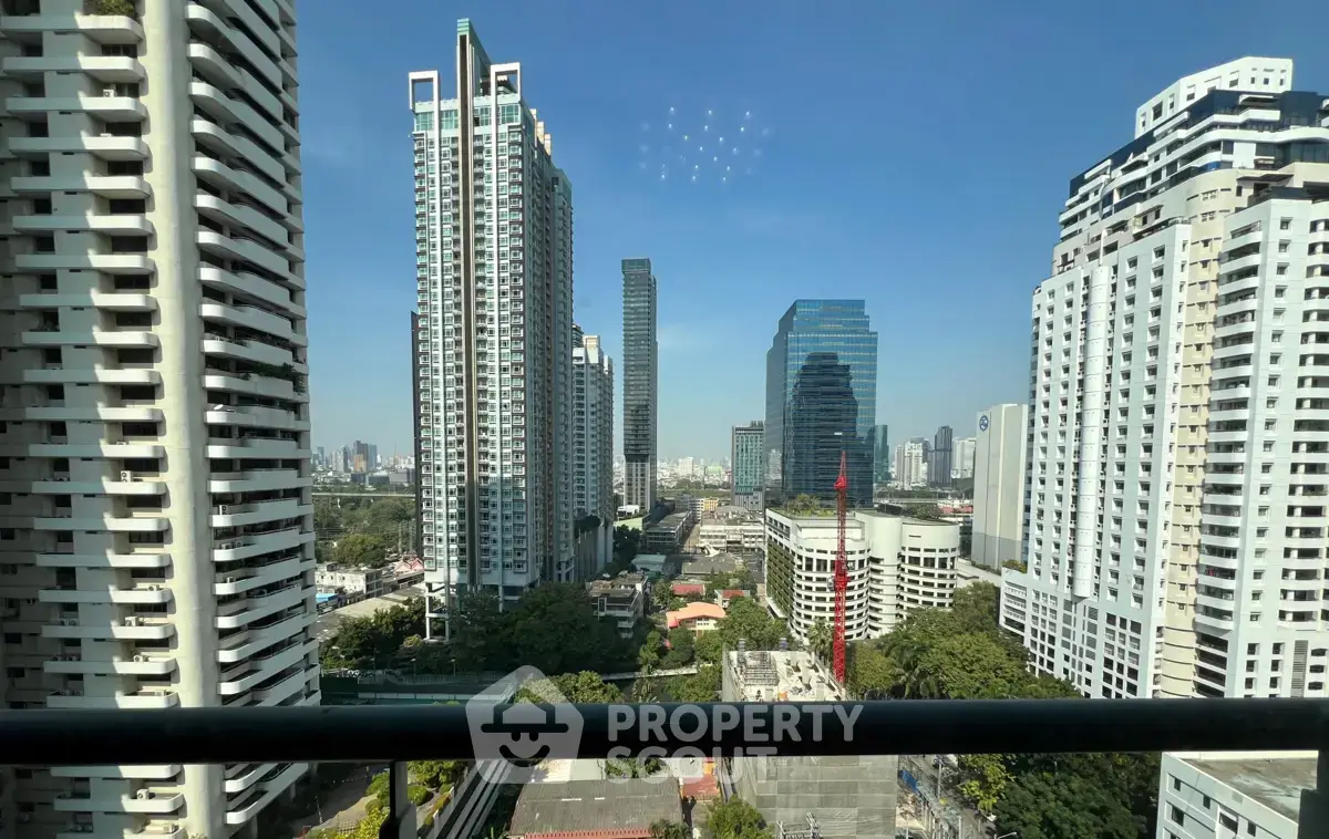 Stunning cityscape view from a high-rise balcony showcasing modern skyscrapers and urban skyline.