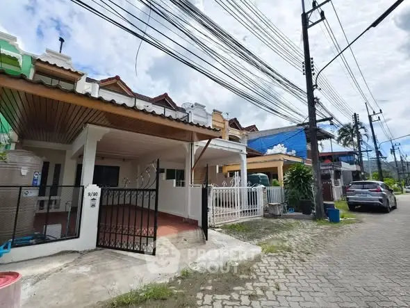 Charming residential street view with cozy townhouses and lush greenery.