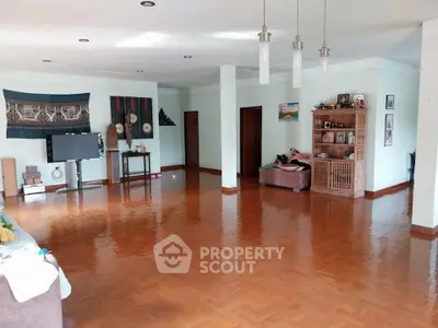 Spacious living room with polished wooden floors and modern decor