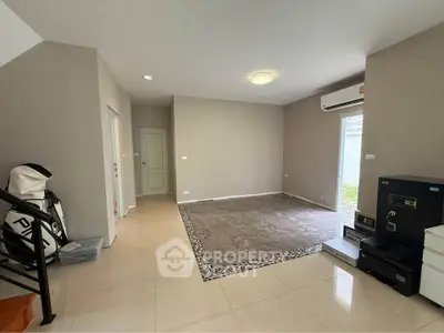Spacious modern living room with elegant tile flooring and natural light