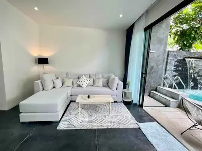 Luxurious living room with poolside view and modern decor