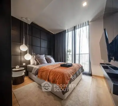 Modern bedroom with stylish decor and floor-to-ceiling windows leading to a balcony.