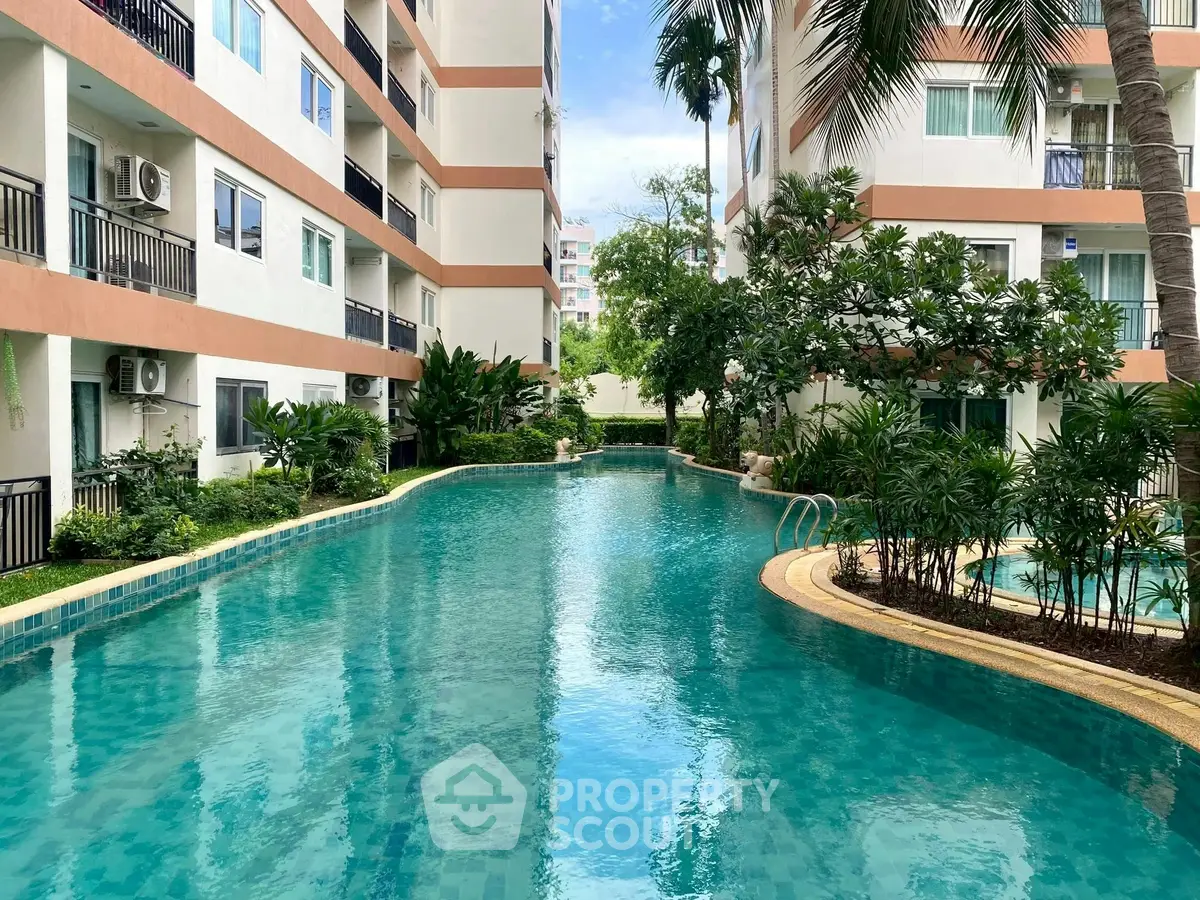 Luxurious apartment complex with stunning pool and lush greenery