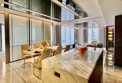 Luxurious open-plan living and dining area with elegant marble finishes and modern decor.