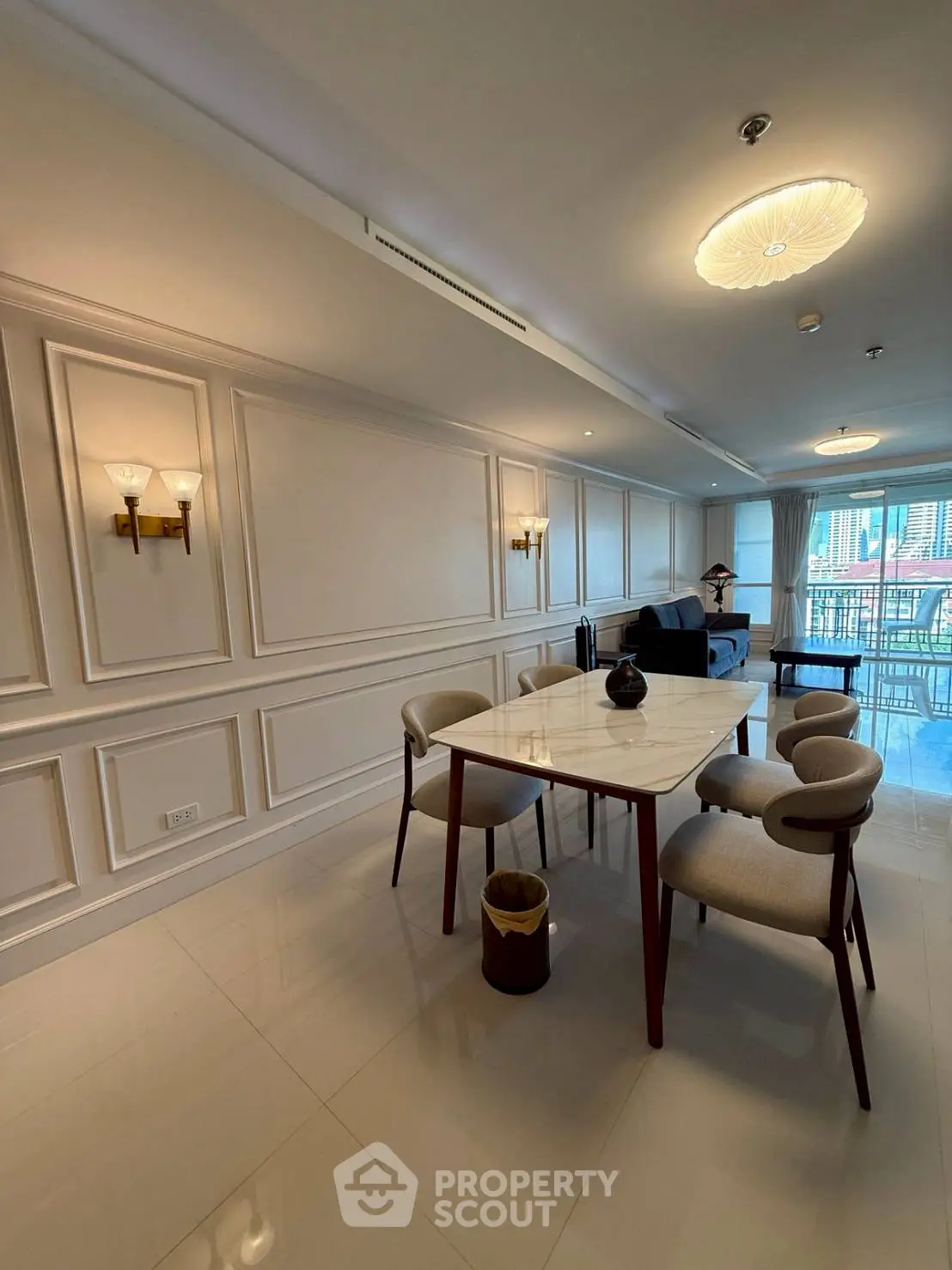 Elegant dining area with modern furniture and city view balcony