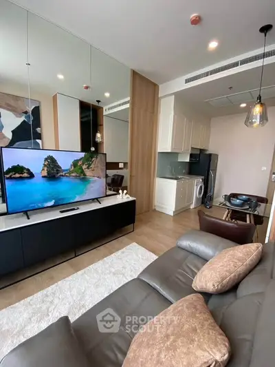 Modern living room with sleek furniture and integrated kitchen appliances in a stylish apartment.