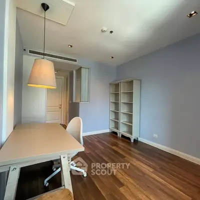 Spacious study room with wooden flooring and modern furniture
