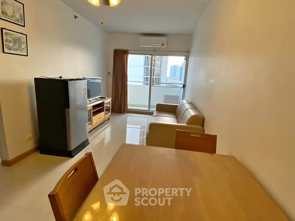 Spacious living room with modern furniture and city view balcony.