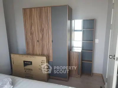 Modern bedroom with stylish wardrobe and new TV box, perfect for contemporary living.