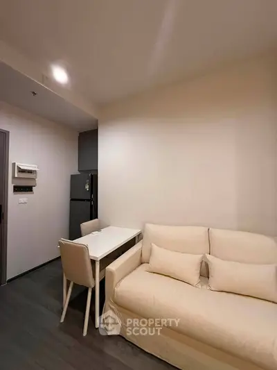 Modern living room with cozy sofa and dining area in stylish apartment