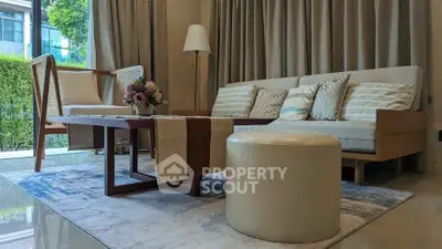 Elegant living room with modern furniture and large window view