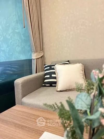 Elegant living room with stylish sofa and decorative pillows, perfect for modern home comfort.