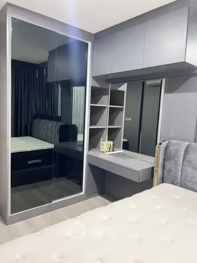 Modern bedroom with sleek mirrored wardrobe and cozy bed