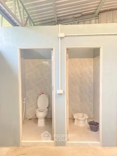 Dual bathroom setup with modern fixtures and separate toilet styles.