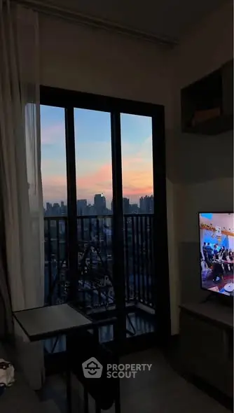 Chic apartment with stunning city view from balcony at sunset