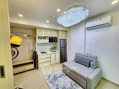Modern studio apartment with elegant lighting and compact kitchen