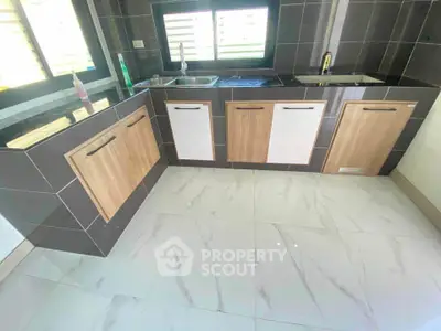 Modern kitchen with sleek cabinetry and dual sinks